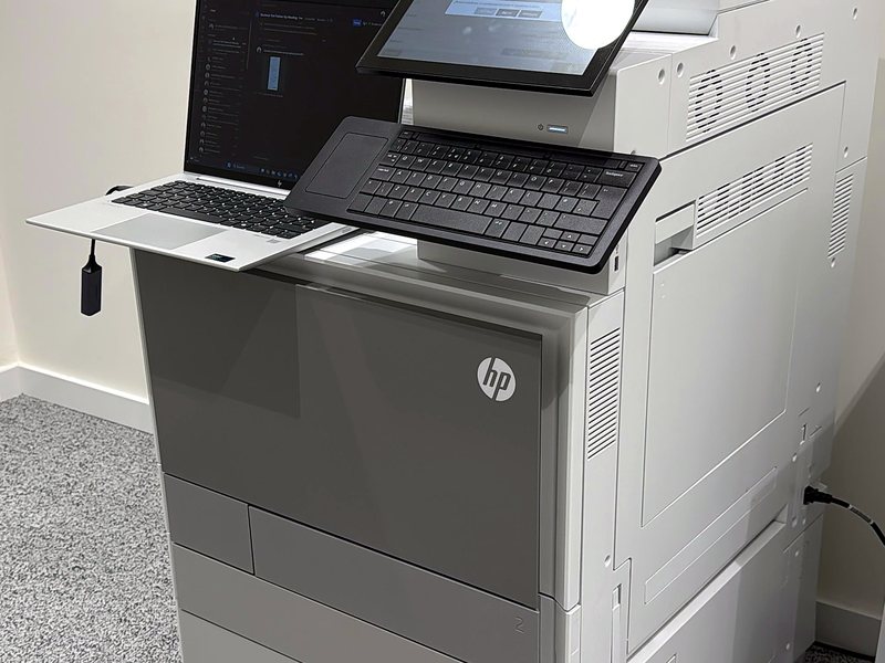 HP multifunction printer installed in an office and configured with a laptop