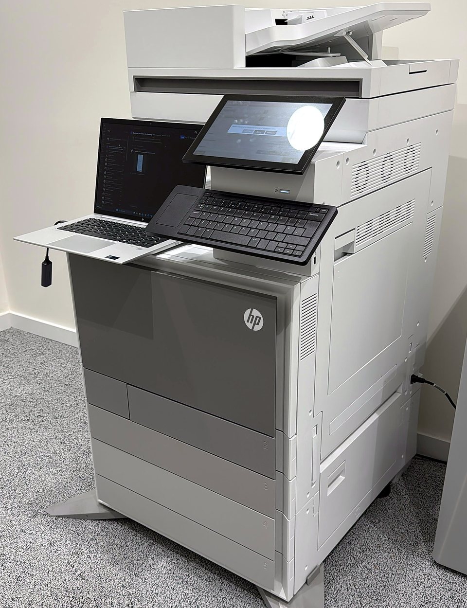 HP multifunction printer installed in an office and configured with a laptop
