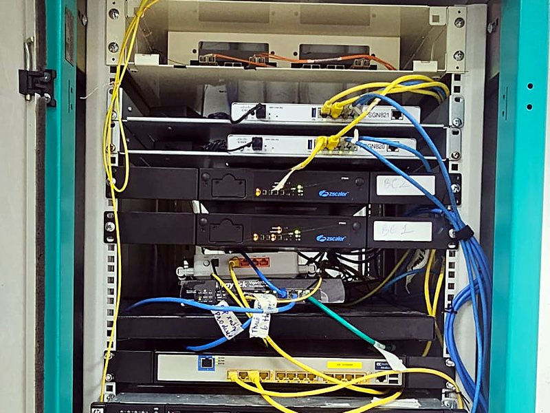 Equipment cabinet with servers, switches, fibre links and a wireless access point installed and cabled